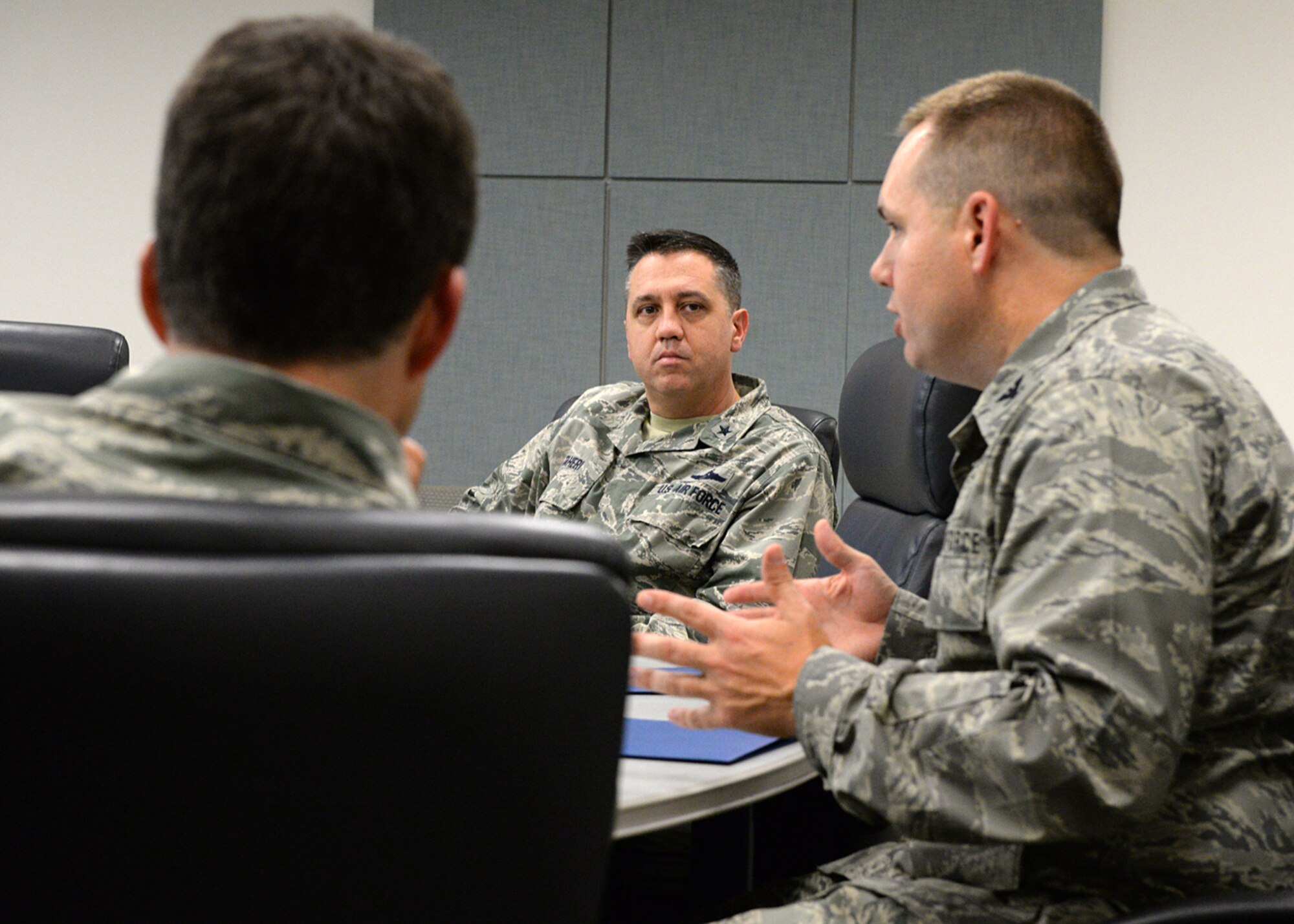 Air National Guard Readiness Center Commander Brig. Gen. Michael. R. Taheri, center, listens to Col. Shawn R. Burrus, 157th Air Refueling Wing commander, during a senior level working group in Building 100 Nov. 7, 2015. During his visit, Taheri received mission briefings, went on a windshield tour of the base and met with Airmen. (U.S. Air National Guard photo by Tech. Sgt. Mark Wyatt)