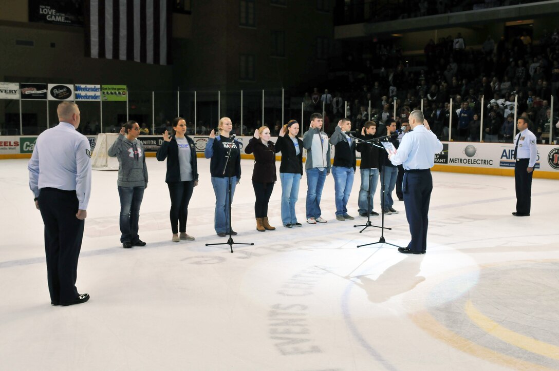 2nd Lt. William Dahna 185 Air Refueling Wing, Sioux City, Iowa, administers the Oath of Enlistment during the first intermission of a hockey game featuring the Sioux City Musketeers versus The Sioux Falls Stampede on Military Appreciation night, in the Tyson Event Center, Sioux City, IA on the 7th of November 2015.  (U.S. Air National Guard photo by Tech Sgt. Bill Wiseman/Released)