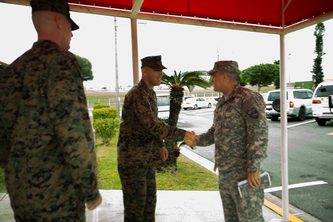 U.S. Army Maj. Gen. Kenneth Roberts, right, shakes hands with U.S. Marine Corps Col. Peter Lee Nov. 5 on Marine Corps Air Station Futenma, Okinawa, Japan. Roberts and other United Nations representatives attended a briefing on Futenma operations followed by a windshield tour of the base. The briefing included topics such as the relocation of the flight line and current capabilities. Roberts is the wartime deputy combined rear area commander for United Nations Command. Lee, a New Rochelle, N.Y., native, is the commanding officer of MCAS Futenma.