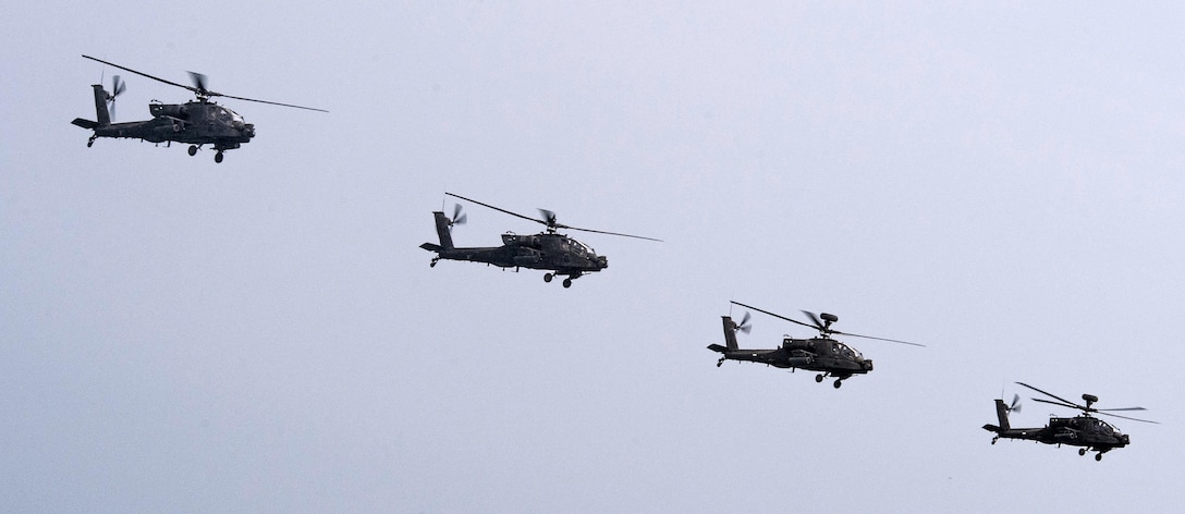 Two U.S. AH-64D Apache helicopters and two Kuwaiti Apache helicopters fly together during a bilateral training exercise in the Arabian Gulf, Nov. 3, 2015. The Apache crews are assigned to the U.S. Army Charlie Troop Heavy Cavalry. The joint exercise provided U.S. forces, which also included U.S. Coast Guard and U.S. Navy, an opportunity to exchange tactics and best practices with Kuwait naval forces. U.S. Navy photo by Petty Officer 2nd Class Torrey W. Lee