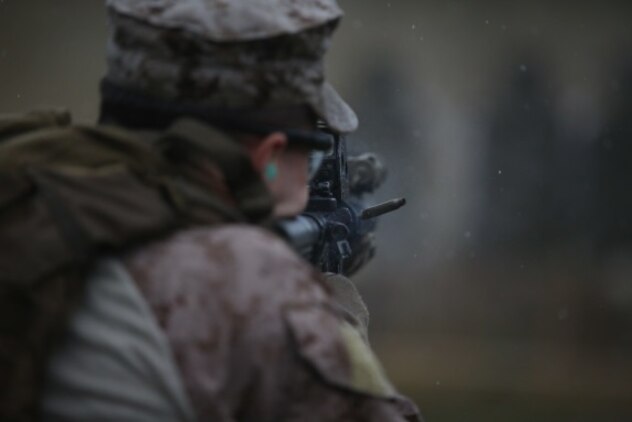 A round leaves the chamber of a Marine’s M4 carbine assault rifle during Expeditionary Operations Training Group’s close quarters tactics course before he switches to use his pistol at Camp Lejeune, N.C., Nov. 3, 2015. These drills tested the Marines with 2nd Reconnaissance Battalion’s ability to change between the two weapons systems, simulating a malfunction or depleting their ammunition. (U.S. Marine Corps photo by Lance Cpl. Dalton A. Precht/Released)