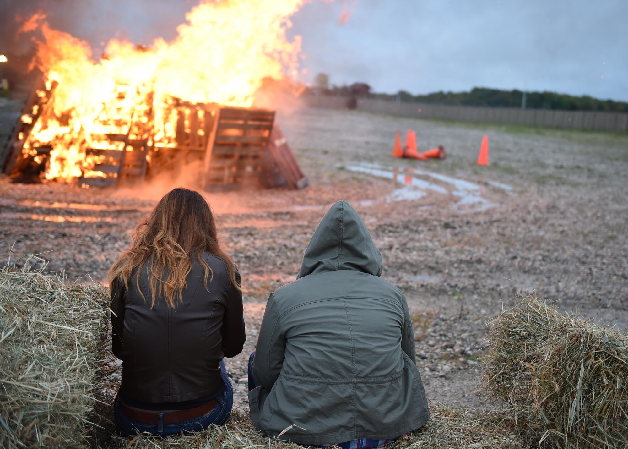 Members of the 910th Airlift Wing enjoy the heat of a bonfire here, Oct. 3, 2015. The bonfire, intended to boost morale and camaraderie, was put together by the USO of northern Ohio and on-base Airman’s groups such as the 5-6 council, Airman’s council and the Top 3. (U.S. Air Force photo/Staff Sgt. Rachel Kocin)