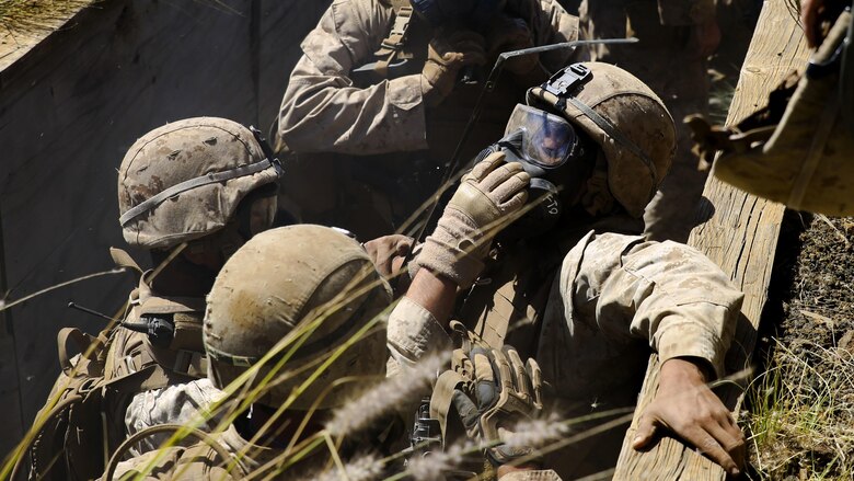 Marines with Kilo Company, 3rd Battalion, 3rd Marine Regiment, help force a gas mask onto a Marine as they are gassed in trenches during training exercise Lava Viper, a staple of their pre-deployment training, at Range 10 at Pohakuloa Training Area, Hawaii, Nov. 4, 2015. The purpose of the training was to provide Marines within the company with an opportunity to utilize various tactics and weapons while organizing within the platoons to accomplish a common mission. Lava Viper provides the Hawaii-based Marines with an opportunity to conduct various movements, live-fire and tactical training before departing for Integrated Training Exercise aboard Marine Air-Ground Combat Center Twentynine Palms, Calif., where the battalion will train and be evaluated as a whole.