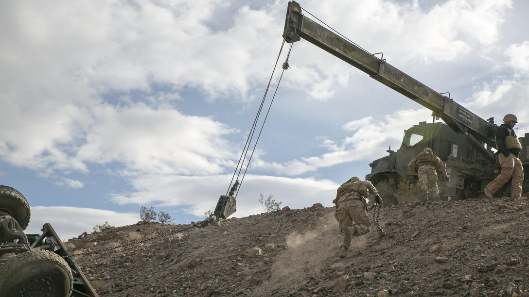 Marines with Transportation Services Company, Combat Logistics Battalion 2, move quickly to recover a staged flipped vehicle during a live-fire exercise as part of Integrated Training Exercise 1-16 at Marine Air Ground Combat Center Twentynine Palms, Calif., Nov. 4, 2015.  The training scenario tested the Marines’ ability to effectively recover a downed vehicle while engaging the enemy in a live-fire scenario. 