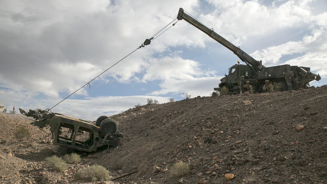 Marines with Transportation Services Company, Combat Logistics Battalion 2, work to recover a staged flipped vehicle during a live-fire exercise as part of Integrated Training Exercise 1-16 at Marine Air Ground Combat Center Twentynine Palms, Calif., Nov. 4, 2015. The training scenario tested the Marines’ ability to effectively recover a downed vehicle while engaging the enemy in a live-fire scenario. 