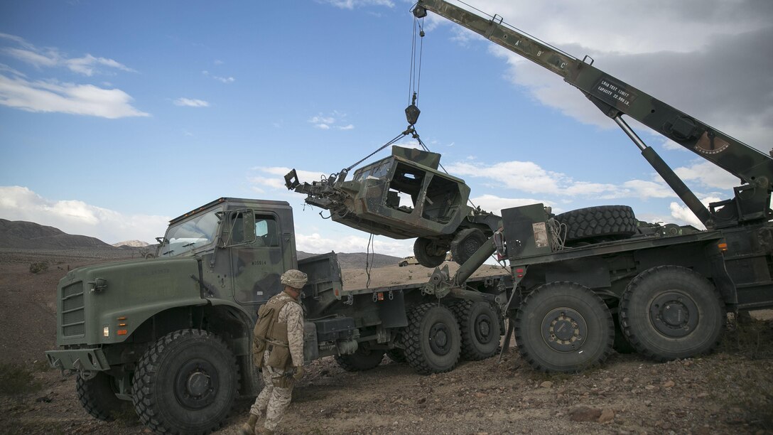 Marines with Transportation Services Company, Combat Logistics Battalion 2, load a wrecked vehicle during a live-fire vehicle recovery exercise as part of Integrated Training Exercise 1-16 at Marine Air Ground Combat Center Twentynine Palms, Calif., Nov. 4, 2015. During ITX, Marines demonstrate core essential tasks and conduct offensive and defensive stability operations. 