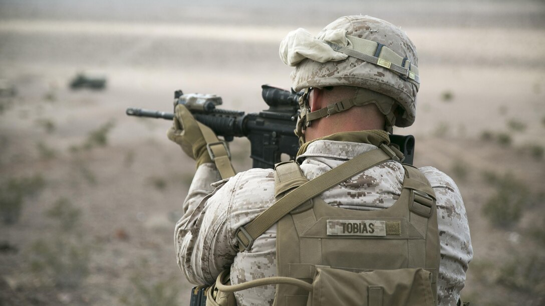 1st Lt. Noah Tobias, platoon commander for 1st Platoon, Charlie Company, 2nd Law Enforcement Battalion, provides security during a live-fire vehicle recovery exercise as part of Integrated Training Exercise 1-16 at Marine Air Ground Combat Center Twentynine Palms, Calif., Nov. 4, 2015. The Marines of 2nd Law Enforcement Battalion are embedded with Transportation Services Company, Combat Logistics Battalion 2, to provide security during the exercise, allowing the wrecker team to focus on the mission. 