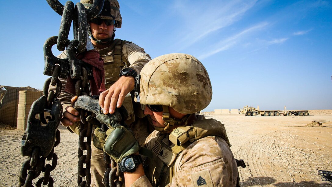 U.S. Marine Sgt. Zackary Cleveland, a motor transport operator with Marine Wing Support Squadron 372, and Sgt. Edward Hooper, an electrician with Engineer Company, Combat Logistics Battalion 1, both currently deployed in support of Special Purpose Marine Air Ground Task Force-Crisis Response-Central Command 16.1, prepare the hook block of a MAC-50 Crane to move Alaskan walls at Al-Taqaddum Air Base, Iraq, Oct. 25, 2015. These Marines are emplacing security measures to protect the Combined Joint Task Force - Operation Inherent Resolve advise and assist site. 