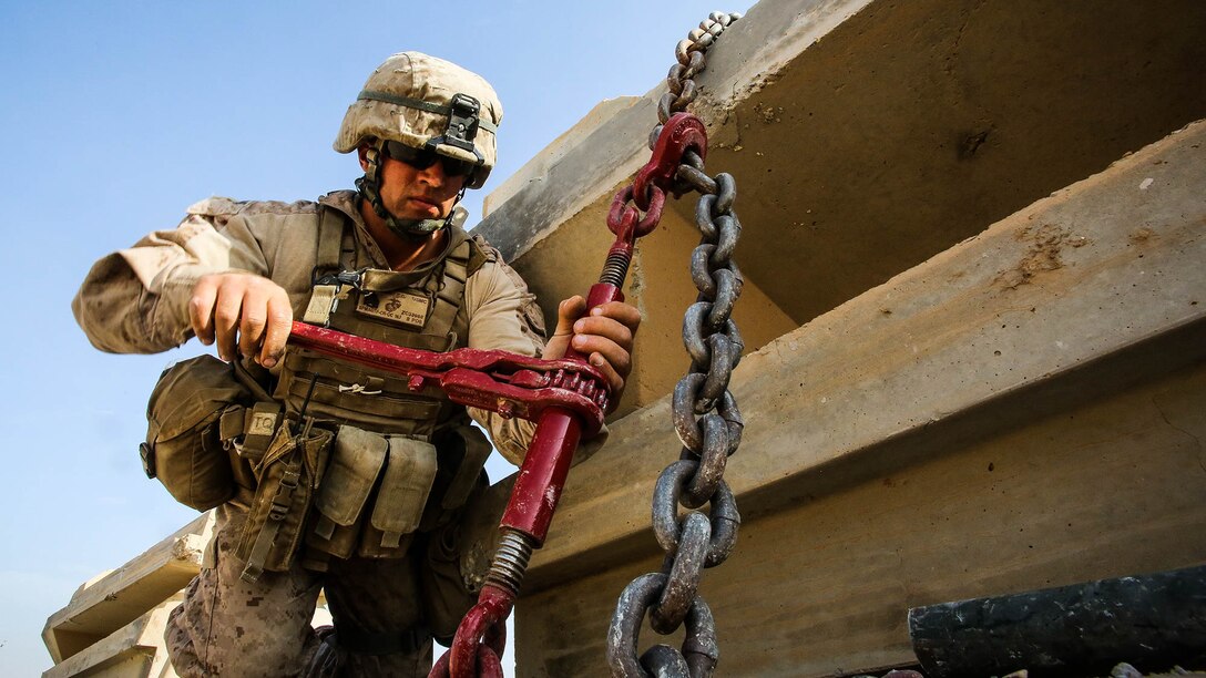 U.S. Marine Sgt. Zackary Cleveland, a motor transport operator with Marine Wing Support Squadron 372, currently deployed in support of Special Purpose Marine Air Ground Task Force-Crisis Response-Central Command 16.1, tightens Alaskan walls onto a Palletized Loading System to be transported at Al Taqaddum Air Base, Iraq, Oct. 25, 2015. The installation of the barriers is in support of the Combined Joint Task Force - Operation Inherent Resolve mission to degrade and defeat the Islamic State of Iraq and the Levant. 