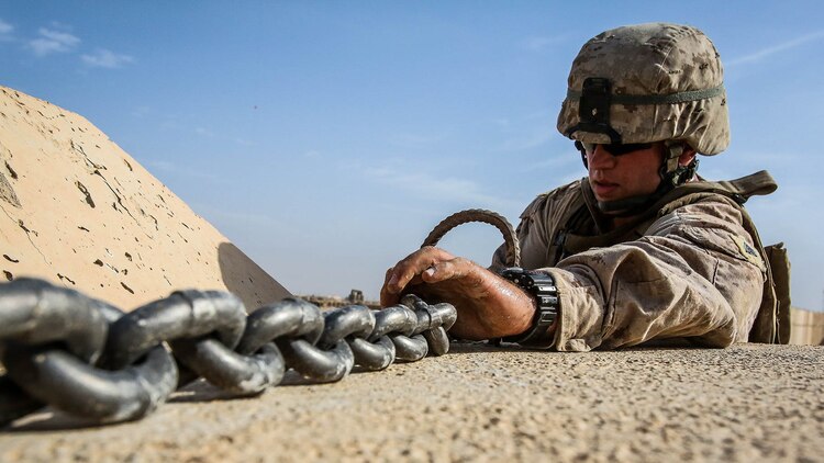U.S. Marine Sgt. Zackary Cleveland, a motor transport operator with Marine Wing Support Squadron 372, currently deployed in support of Special Purpose Marine Air Ground Task Force-Crisis Response-Central Command 16.1, tightens Alaskan walls onto a Palletized Loading System to be transported at Al-Taqaddum Air Base, Iraq, Oct. 25, 2015. These coalition barriers are placed around key structures to provide protection to Combined Joint Task Force – Operation Inherent Resolve personnel.
