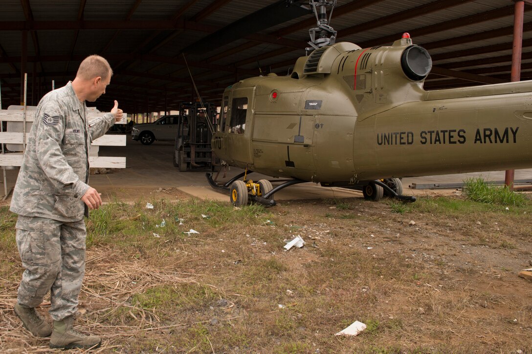 U.S. Air Force Tech. Sgt. Christopher Holmes, aircraft electrician, 913th Maintenance Squadron, guides forklift operator Master Sgt. Jerry Killian, fabrication supervisor, 913 MXS, while transporting a Bell UH-1C Iroquois to a staging area at the city recycling center in Jacksonville, Ark., Nov. 3, 2015. The newly restored Vietnam era helicopter was returned to the Jacksonville Museum of Military History the next day. (U.S. Air Force photo by Master Sgt. Jeff Walston/Released)