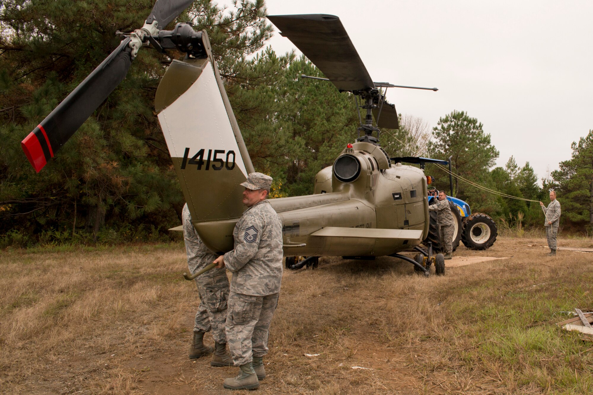 U.S. Air Force Airmen move a newly restored Vietnam era Bell UH-1C Iroquois helicopter to a staging area at the city recycling center in Jacksonville, Ark., Nov. 3, 2015. The helicopter was returned to the Jacksonville Museum of Military History for display the next day. (U.S. Air Force photo by Master Sgt. Jeff Walston/Released)