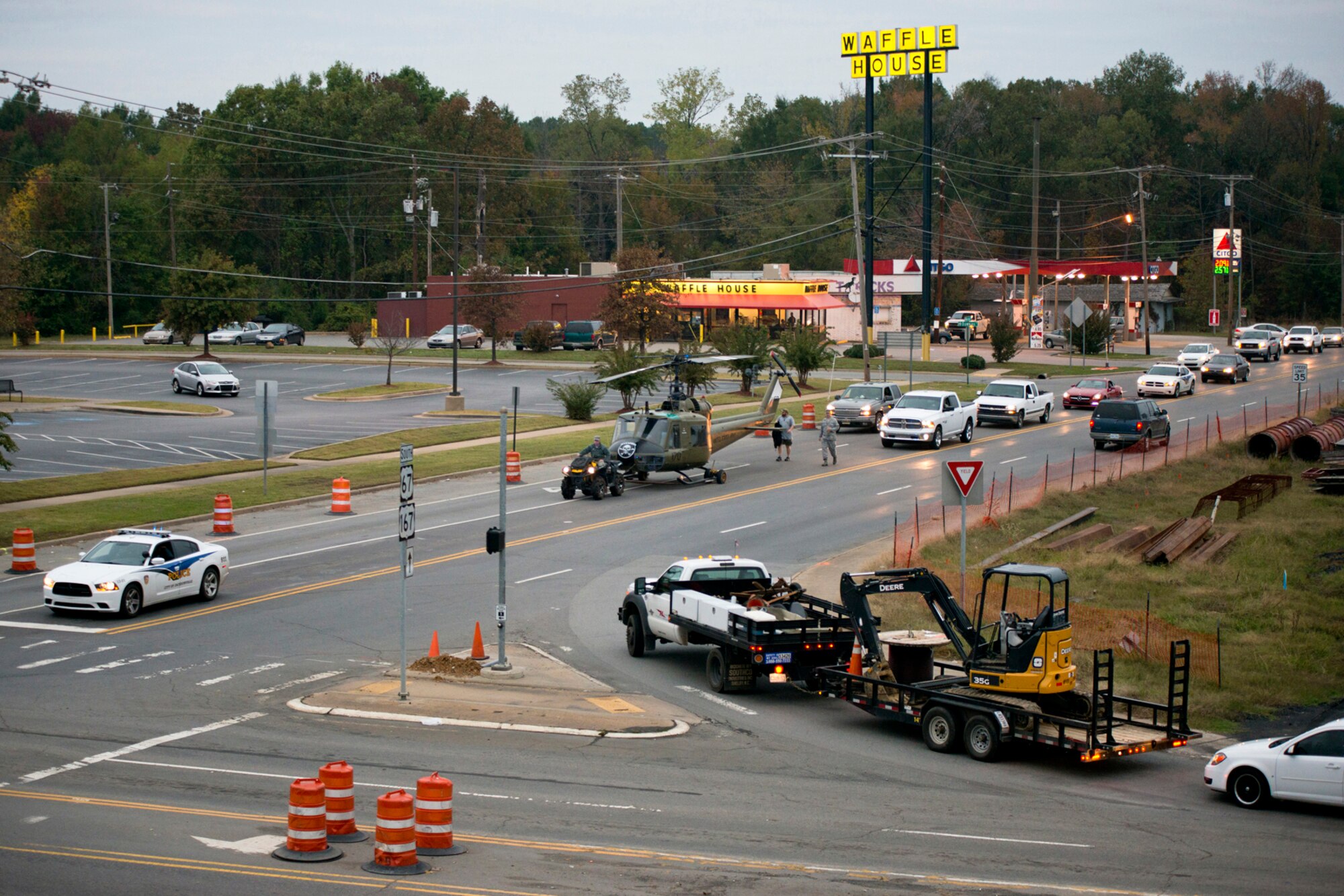 Jacksonville City Police escort a Bell UH-1C Iroquois Vietnam era helicopter as it is transported back to the Jacksonville Museum of Military History in Jacksonville, Ark., for display on Nov. 4, 2015. U.S. Air Force Airmen from the 913th Airlift Group at Little Rock Air Force Base, Ark., helped restore the helicopter to its original combat color scheme and returned it to the Jacksonville Museum of Military History for display. (U.S. Air Force photo by Master Sgt. Jeff Walston/Released)