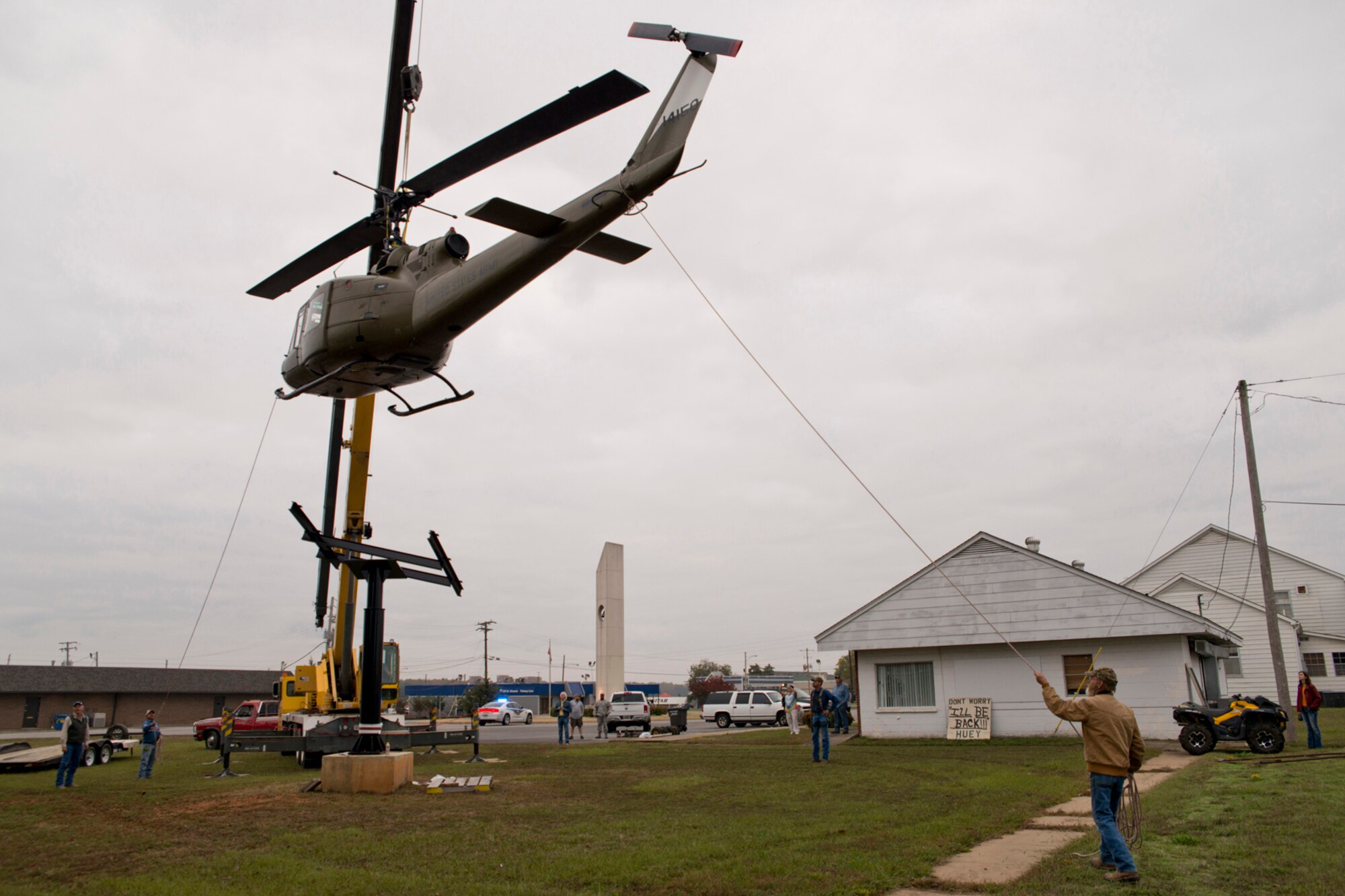 A newly restored Bell UH-1C Iroquois helicopter from the Vietnam era is lowered into place on a pedestal at the Jacksonville Museum of Military History in Jacksonville, Ark., Nov. 4, 2015. The return of the Vietnam era helicopter to the museum marks the end of a restoration project that started in June 2015, which brought both military and civilian communities together to restore the aircraft for future generations to see at the museum. (U.S. Air Force photo by Master Sgt. Jeff Walston/Released)