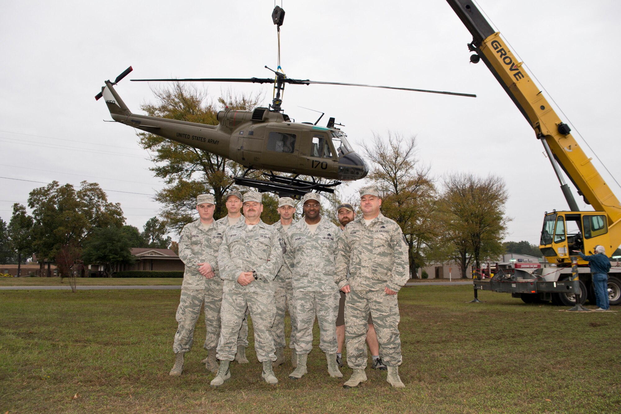 (From Left) U.S. Air Force Staff Sgt. Brandon Thelen, sheet metal craftsman, Tech. Sgt. Christopher Holmes, aircraft electrician, Senior Master Sgt. Harry Watson, aircraft electrician supervisor, Master Sgt. Michael Jester, fabrication flight chief, Senior Master Sgt. Jesse Brown, hydraulics supervisor, Kevin Wagers, civilian engine shop mechanic and Master Sgt. Jerry Killian, fabrication supervisor, pose for a photo at the Jacksonville Museum of Military History after the Bell UH-1C Iroquois helicopter they spent the last few months restoring is returned to its pedestal in front of the museum , Nov. 4, 2015. All the Airmen work at the 913th Maintenance Squadron at Little Rock Air Force Base, Ark. (U.S. Air Force photo by Master Sgt. Jeff Walston/Released)