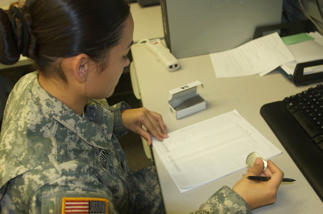 Spc. Patrisha Querubin from A Company, 2/319th, 3rd BDE 104th Inf. Div., provides support to the 120th AG battalion during annual training with creating ID tags with pertinent information such as blood type and religion preferences for initial entry soldiers at Fort Jackson, Aug. 7, 2015. (U.S. Army photo by Maj. Satomi Mack-Martin/Released)