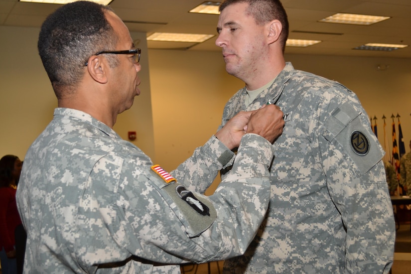 Maj. Gen. A.C. Roper, commander 80th Training Command, awards the Army Commendation Medal to Maj. David Porter, 102nd Training Division, for winning the 80th TC Instructor of the Year Award, during a ceremony at Fort Knox, Ky., Nov. 7, 2015.