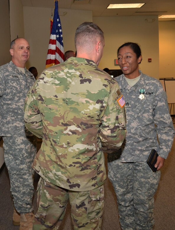 Brig. Gen. Thomas P. Evans, deputy commander 80th Training Command, looks on as Brig. Gen. Jason Walrath, commander 100th Training Division, congratulates the 80th TC Instructor Of the Year in the noncommissioned officer category, Staff Sgt. Jadrian Whitfield, 100th TD, during an award ceremony at Fort Knox, Ky., Nov. 7, 2015.