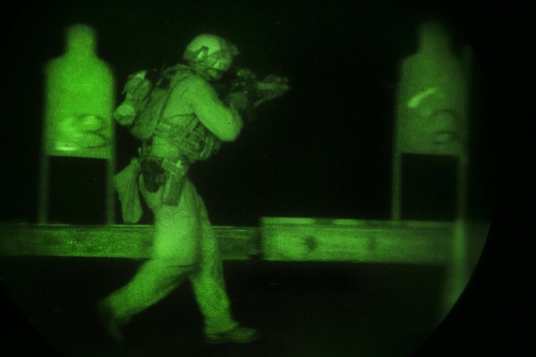 As seen through a night-vision device, a U.S. Marine aims at his target during a deck shoot aboard the amphibious assault ship USS Essex in the Indian Ocean, Oct. 31, 2015. U.S. Marine Corps photo by Sgt. Anna Albrecht
