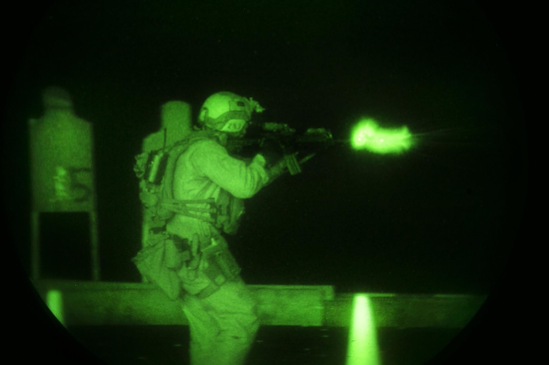 As seen through a night-vision device, a U.S. Marine fires at his target during a deck shoot aboard the amphibious assault ship USS Essex in the Indian Ocean, Oct. 31, 2015. U.S. Marine Corps photo by Sgt. Anna Albrecht