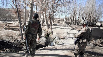 An Afghan National army and Oklahoma National Guard Soldier patrol through Paktya Province, Afghanistan, during Operation Shamshir III, Nov. 29, 2011. The operation was executed to degrade the insurgency's ability to fight by eliminating safe havens and destroying weapon caches.