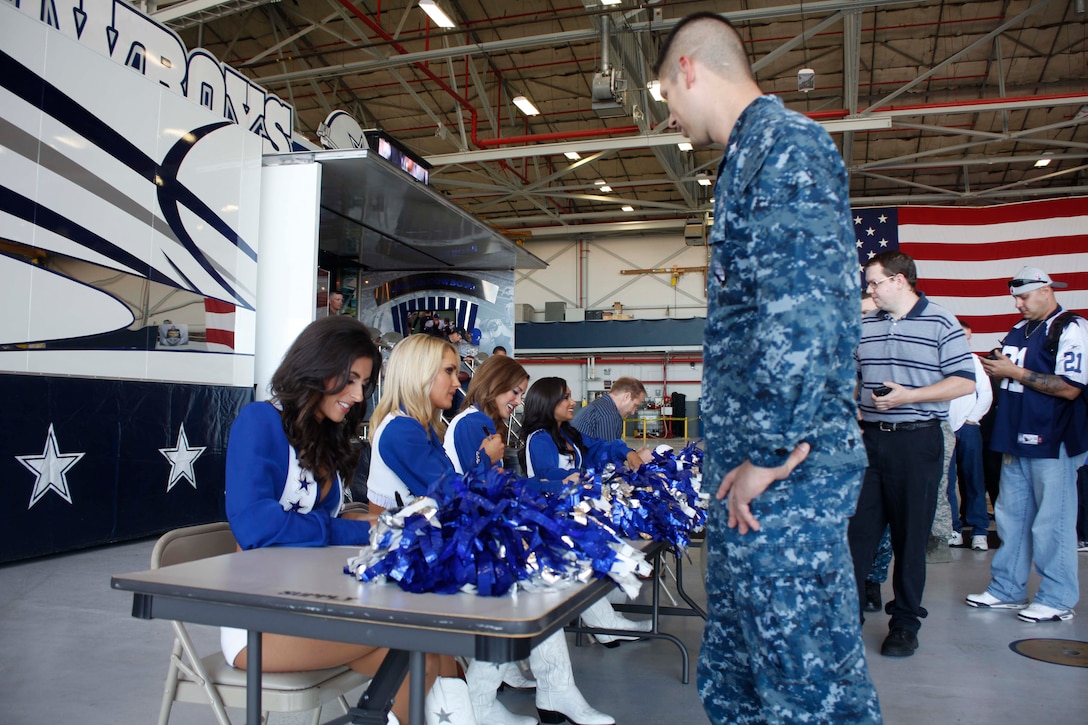 Dallas Cowboys cheerleaders and Chad Hennings, a Dallas Cowboys alumni, meets and greets service members and their families during the Cowboys Military Appreciation event Nov. 6, 2015 aboard Naval Air Station Joint Reserve Base Fort Worth, Texas. The event was held to show the Dallas Cowboys’ and the Gene and Jerry Jones Family Foundation’s pride and support for the nation’s military.