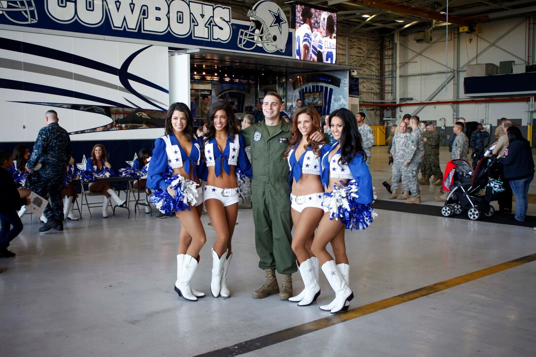 Cheerleaders from the Dallas Cowboys take pictures and sign autographs with service members and their families during the Cowboys Military Appreciation event on Nov. 6, 2015 aboard Naval Air Station Joint Reserve Base Fort Worth, Texas. The cheerleaders visited the base to show the support of local service members and their families on behalf of the Dallas Cowboys and the Gene and Jerry Jones Family Foundation.