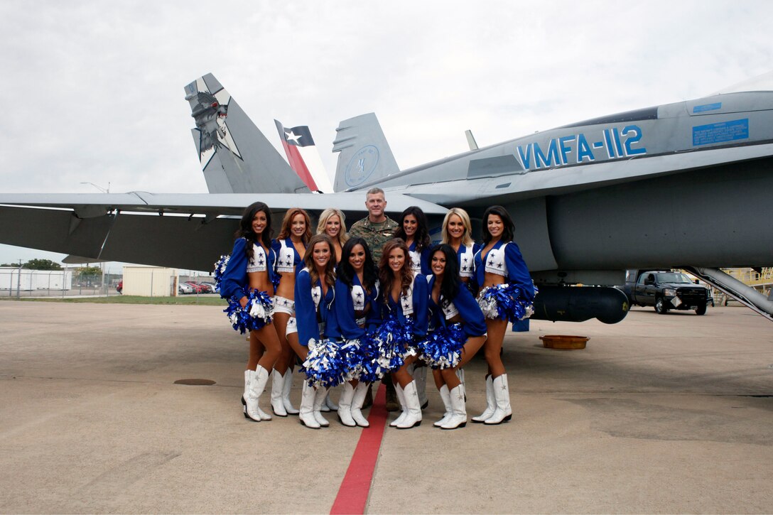 Dallas Cowboys cheerleaders pose with Col. Paul T. Patrick, commanding officer of Marine Aircraft Group 41, in front of Marine Fighter Attack Squadron 112’s F/A-18 Hornet aircraft Nov. 6, 2015, aboard Naval Air Station Joint Reserve Base Fort Worth, Texas. The cheerleaders visited the base to show support for service members and their families during the Cowboys’ Military Appreciation event.