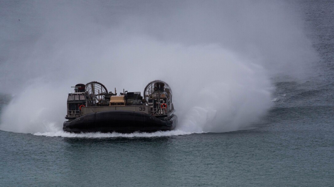 A landing craft air-cushion, or LCAC, transporting U.S. Marines, with the 26th Marine Expeditionary Unit and Portuguese Marines from the USS Arlington, Kearsarge Amphibious Ready Group moves towards Pinheiro Da Cruz, Praia Da Raposa beach in Portugal, to participate in a combined amphibious assault exercise, Oct. 20, 2015, during Trident Juncture 15. Trident Juncture is a NATO-led exercise designed to certify NATO response forces and develop interoperability among participating NATO and partner nations. 
