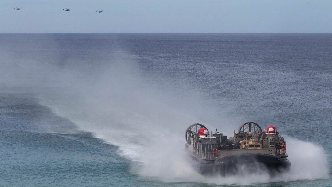 A landing craft air-cushion, or LCAC, transporting U.S. Marines, with the 26th Marine Expeditionary Unit and Portuguese Marines from the USS Arlington, Kearsarge Amphibious Ready Group moves towards Pinheiro Da Cruz, Praia Da Raposa beach in Portugal, to participate in a combined amphibious assault exercise, Oct. 20, 2015, during Trident Juncture 15. Trident Juncture is a NATO-led exercise designed to certify NATO response forces and develop interoperability among participating NATO and partner nations. 