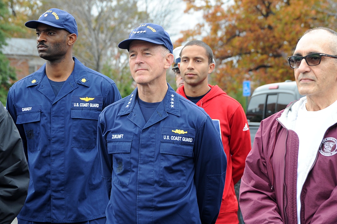 Coast Guard Commandant Adm. Paul F. Zukunft takes part in the Coast Guard's Flags Across America event in Arlington, Va., Nov. 7, 2015. During the event, Coast Guard members, their families, friends, and former members placed Coast Guard flags and national ensigns on the graves of Coast Guardsmen ahead of Veterans Day. U.S. Coast Guard photo by Petty Officer 3rd Class Lisa A. Ferdinando
