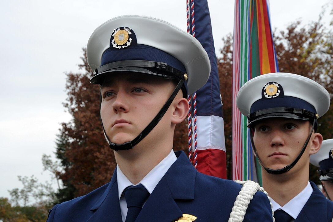 The Coast Guard Honor Guard takes part in the Coast Guard's Flags Across America event at Arlington National Cemetery in Arlington, Va., Nov. 7, 2015. During the event, Coast Guard members, their families, friends, and former members placed Coast Guard flags and national ensigns on the graves of Coast Guardsmen ahead of Veterans Day. U.S. Coast Guard photo by Petty Officer 3rd Class Lisa A. Ferdinando
