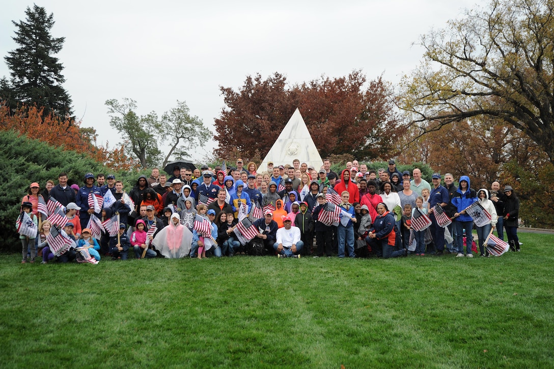 Coast Guardsmen, their families and other volunteers take part in the Coast Guard's Flags Across America event at Arlington National Cemetery in Arlington, Va., Nov. 7, 2015. During the event, the volunteers placed Coast Guard flags and national ensigns on the graves of Coast Guardsmen ahead of Veterans Day. U.S. Coast Guard photo by Petty Officer 3rd Class Lisa A. Ferdinando