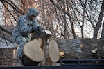 A Utah National Guard Soldier assists with clean-up efforts after windstorms damaged several building, power lines and trees throughout Davis County in Utah Dec. 5, 2011. About 200 National Guard Soldiers and Airmen, using about 70 pieces of heavy equipment, were activated to quickly remove the debris.