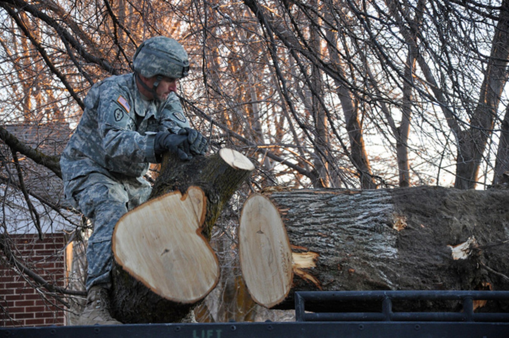 A Utah National Guard Soldier assists with clean-up efforts after windstorms damaged several building, power lines and trees throughout Davis County in Utah Dec. 5, 2011. About 200 National Guard Soldiers and Airmen, using about 70 pieces of heavy equipment, were activated to quickly remove the debris.