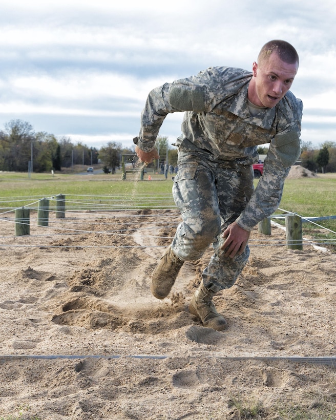 A soldier runs on sand on the obstacle course during the 2015 Oklahoma Army National Guard Best Warrior Competition on Camp Gruber in Braggs, Okla., Nov. 7, 2015. U.S. Army photo by Sgt. 1st Class Kendall James