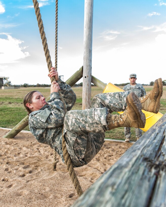 A soldier swings from a chain on one of the nine stations during the 2015 Oklahoma Army National Guard Best Warrior Competition on Camp Gruber in Braggs, Okla., Nov. 7, 2015. U.S. Army photo by Sgt. 1st Class Kendall James