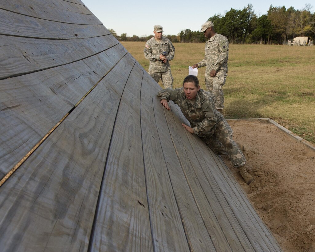 A soldier tackles a wall obstacle during the 2015 Oklahoma Army National Guard Best Warrior Competition on Camp Gruber in Braggs, Okla., Nov. 7, 2015. U.S Army photo by Sgt. 1st Class Kendall James
