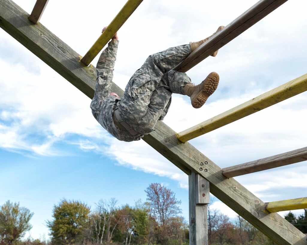 A soldier crosses from one bar to the next on the obstacle course during the 2015 Oklahoma Army National Guard Best Warrior Competition on Camp Gruber in Braggs, Okla., Nov. 7, 2015. U.S. Army photo by Sgt. 1st Class Kendall James