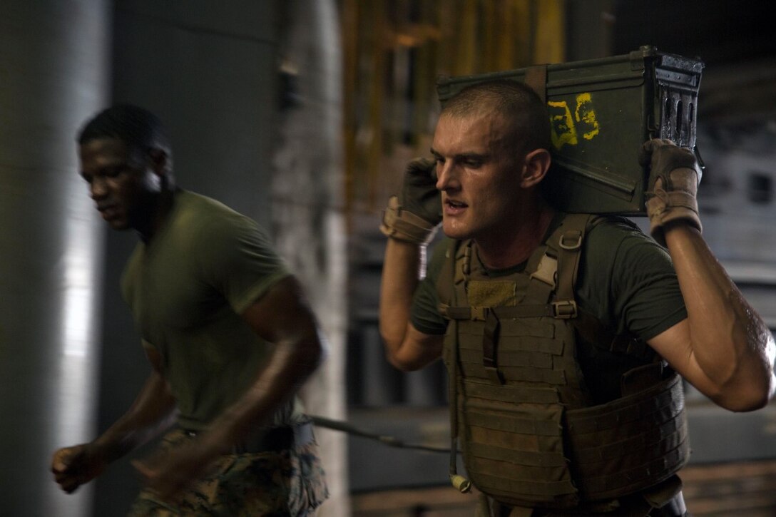 GULF OF ADEN (Oct. 17, 2015) U.S Marine Sgt. Russell Bloxsom, right, sprints with an ammo can during the combat conditioning portion of a Marine Corps Martial Arts Program black belt course aboard the USS Rushmore (LSD 47). Bloxsom is an amphibious assault vehicle section leader with Kilo Company, Battalion Landing Team 3rd Battalion, 1st Marine Regiment, 15th Marine Expeditionary Unit. In addition enhancing hand-to-hand combat skills, MCMAP sharpens the decision making and mental toughness of the Marines by instilling a warrior ethos. (U.S. Marine Corps photo by Sgt. Emmanuel Ramos/Released)