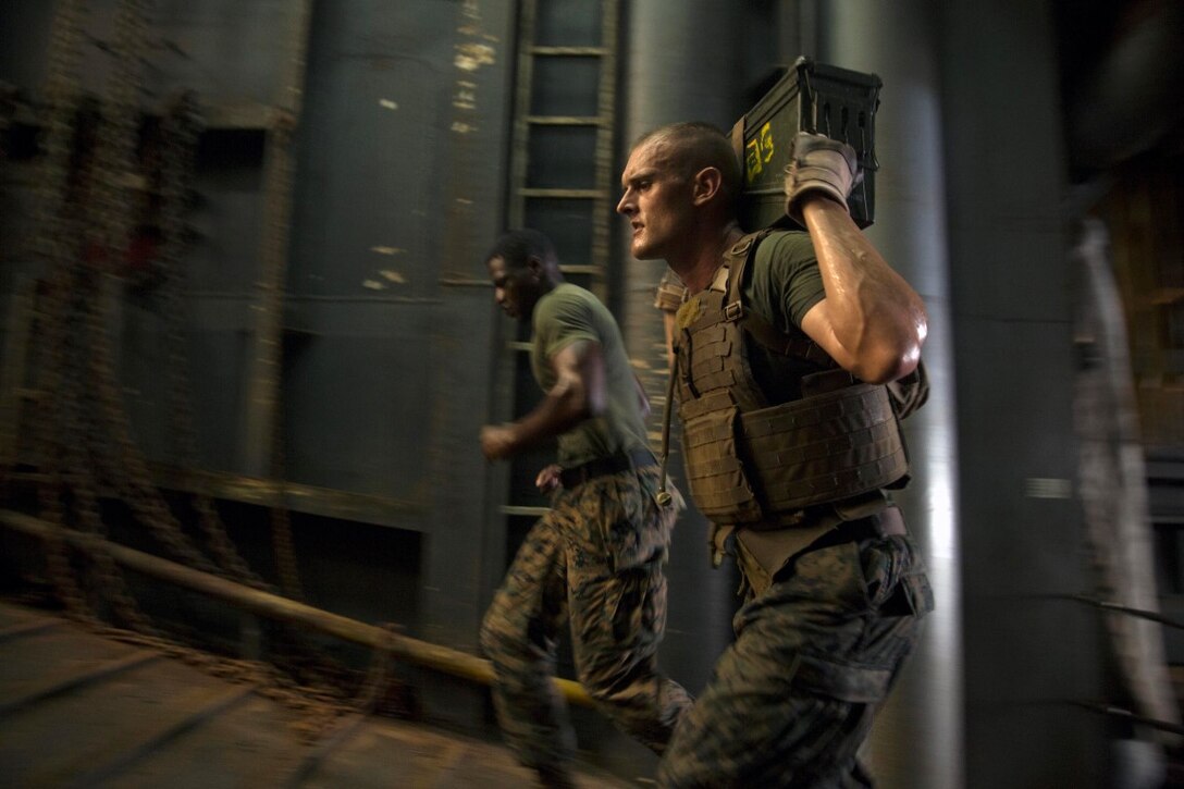 GULF OF ADEN (Oct. 17, 2015) U.S Marine Sgt. Russell Bloxsom, right, sprints with an ammo can during the combat conditioning portion of a Marine Corps Martial Arts Program black belt course aboard the USS Rushmore (LSD 47). Bloxsom is an amphibious assault vehicle section leader with Kilo Company, Battalion Landing Team 3rd Battalion, 1st Marine Regiment, 15th Marine Expeditionary Unit. In addition enhancing hand-to-hand combat skills, MCMAP sharpens the decision making and mental toughness of the Marines by instilling a warrior ethos. (U.S. Marine Corps photo by Sgt. Emmanuel Ramos/Released)