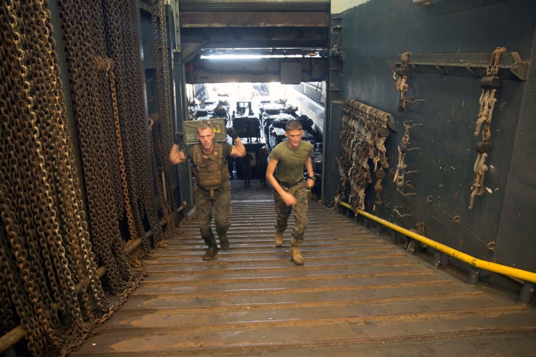 GULF OF ADEN (Oct. 17, 2015) U.S Marine Cpl. Shawn Obrien, left, sprints with an ammo can during the combat conditioning portion of a Marine Corps Martial Arts Program black belt course aboard the USS Rushmore (LSD 47). Obrien is an amphibious assault vehicle crew chief with Kilo Company, Battalion Landing Team 3rd Battalion, 1st Marine Regiment, 15th Marine Expeditionary Unit. In In addition enhancing hand-to-hand combat skills, MCMAP sharpens the decision making and mental toughness of the Marines by instilling a warrior ethos.. (U.S. Marine Corps photo by Sgt. Emmanuel Ramos/Released)