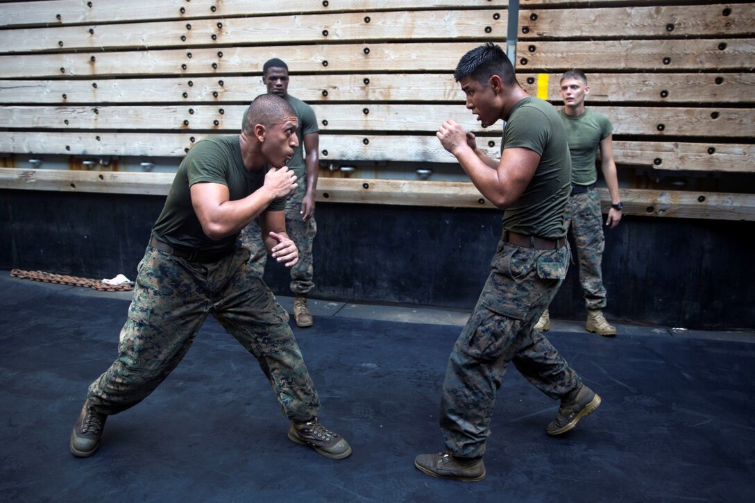 GULF OF ADEN (Oct. 17, 2015) U.S Marine Sgt. Marcos Gonzalez, left, spars with Lance Cpl. Giovanni Carrera during the combat conditioning portion of a Marine Corps Martial Arts Program black belt course aboard the USS Rushmore (LSD 47). Gonzalez is a motor transportation operator with Combat Logistics Battalion 15, 15th Marine Expeditionary Unit. Carrera is an amphibious assault vehicle crewman with Kilo Company, Battalion Landing Team 3rd Battalion, 1st Marine Regiment, 15th MEU. In addition enhancing hand-to-hand combat skills, MCMAP sharpens the decision making and mental toughness of the Marines by instilling a warrior ethos. (U.S. Marine Corps photo by Sgt. Emmanuel Ramos/Released)