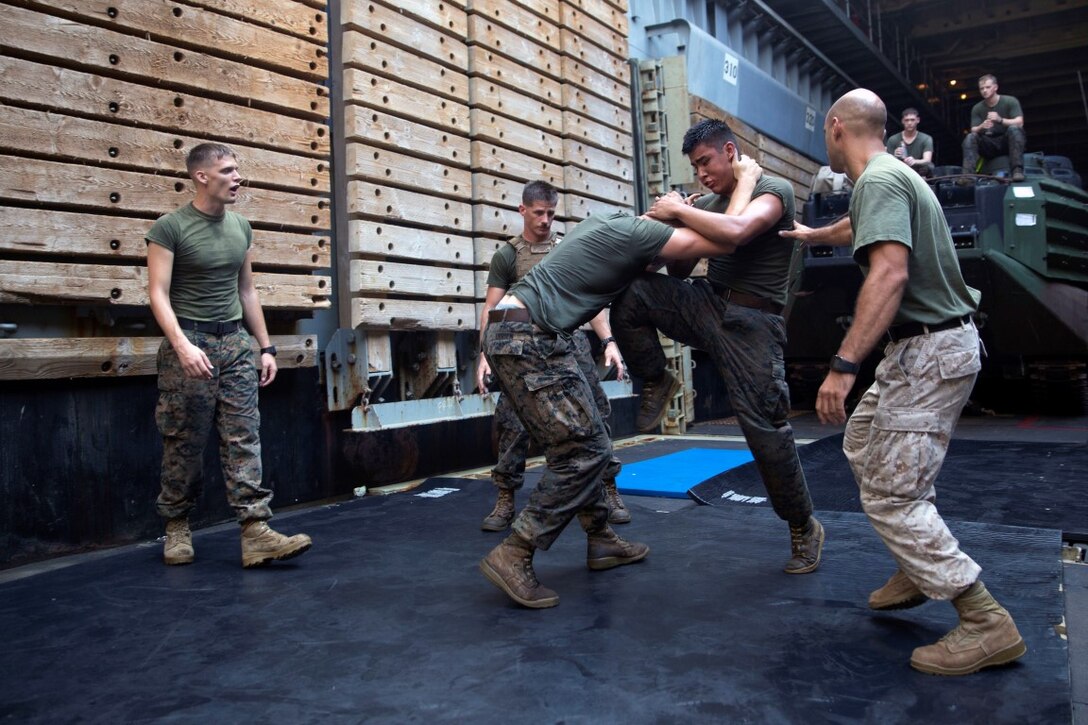 GULF OF ADEN  (Oct. 17, 2015) U.S Marine Lance Cpl Giovanni Carrera, right, spars with Cpl. Shawn Obrien during the combat conditioning portion of a Marine Corps Martial Arts Program black belt course aboard the USS Rushmore (LSD 47). Obrien is an amphibious assault vehicle crew chief and Carrera is an AAV crewman, both with Kilo Company, Battalion Landing Team 3rd Battalion, 1st Marine Regiment, 15th MEU. In addition enhancing hand-to-hand combat skills, MCMAP sharpens the decision making and mental toughness of the Marines by instilling a warrior ethos. (U.S. Marine Corps photo by Sgt. Emmanuel Ramos/Released)