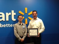 Ben Hulsey, a senior operations manager for Walmart’s Real Estate and Construction division, and his supervisor, Alex May, pose for a photo after Hulsey presented May with an Employer Support of the Guard and Reserve (ESGR) “Patriot Award” in Bentonville, Ark., Sept. 16, 2015. Hulsey is also an Air Force Reserve captain with the 913th Airlift Group at Little Rock Air Force Base, Ark., and nominate his employer for the award in gratitude for the support he has received during his military career. (Courtesy photo)      