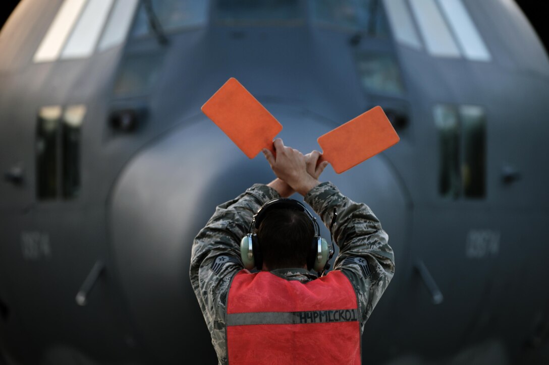 Air Force Staff Sgt. Cory Shwartz guides an HC-130 Hercules aircraft during Southern Strike 16 at the Trent Lott Combat Readiness Training Center in Gulfport, Miss., Nov. 5, 2015. Shwartz is assigned to the New York Air National Guard's 102nd Rescue Squadron, 106th Rescue Wing. New York Air National Guard photo by Staff Sgt. Christopher S. Muncy.
