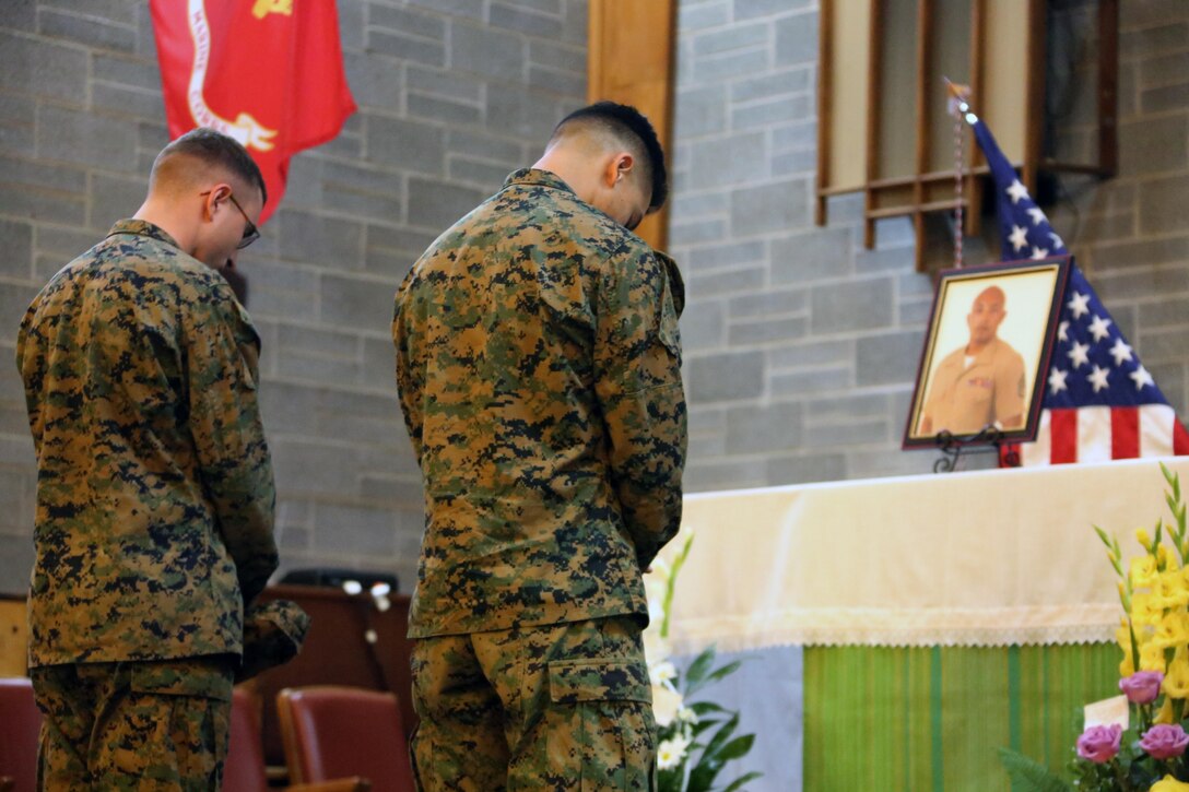 Marines share a moment of silence in memory of fallen Staff Sgt. Denver Sugano during a memorial service at Marine Corps Air Station New River, N.C., Nov. 4, 2015. Sugano faithfully served in the Marine Corps for 13 years, primarily serving as a flight equipment technician and a Marine recruiter. Sugano participated in three Unit Deployment Programs, assisting with hurricane Sandy relief efforts and deploying in support of the 26th Marine Expeditionary Unit. Family, friends and fellow Marines remember Sugano for his dedication to his beloved Corps and his family. (U.S. Marine Corps photo by Cpl. N.W. Huertas/Released)