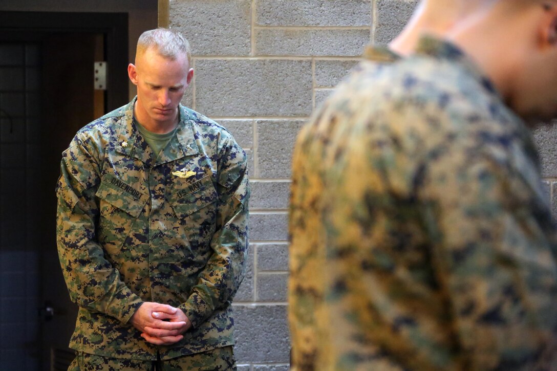 Lieutenant  Cmdr. Bryan Davenport shares in prayer during a memorial service for Staff Sgt. Denver Sugano at Marine Corps Air Station New River, N.C., Nov. 4, 2015. Sugano faithfully served in the Marine Corps for 13 years, primarily serving as a flight equipment technician and a Marine recruiter. Sugano participated in three Unit Deployment Programs, assisted with Hurricane Sandy relief efforts and deploying in support of the 26th Marine Expeditionary Unit. Family, friends and fellow Marines remember Sugano for his dedication to his beloved Corps and his family. Davenport is a Chaplin with Marine Wing Support Squadron 274. (U.S. Marine Corps photo by Cpl. N.W. Huertas/Released)