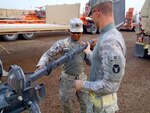 Army National guard member's Army Spc. Tyler Dooley and Capt. Joseph Sanganoo ensure the Rhino of a Mine Resistant Ambush Protected vehicle is working properly before going on a recent convoy in Iraq. Dooley and Sanganoo, along with the rest of soldiers from 1-194 AR (CAB), are part of the Minnesota-based 1st Brigade Combat Team, 34th Infantry "Red Bull" Division, currently deployed to Kuwait in support of Operation New Dawn, the final stage in post-combat operations in Iraq.