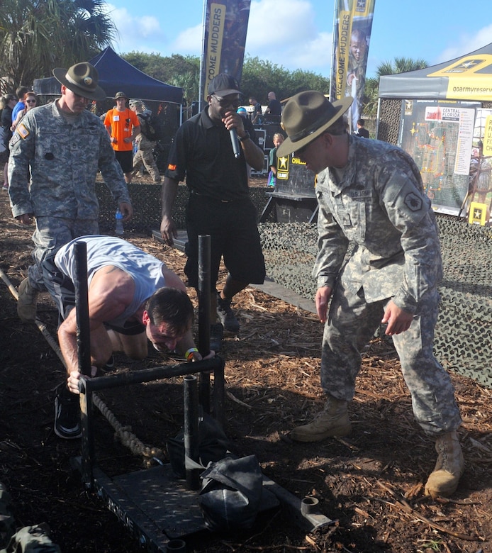 A participant pushes a sled while racing through the Army Reserve Fitness Challenge during day one of the 2015 Tough Mudder at Palm Bay Fla., Nov. 8. A team of drill sergeants was present motivating and critiquing the participants as they took on the challenge. The drill sergeants guaranteed that competitors got a feel of how it’s like working under stress and urgency by yelling commands and creating a stressful environment while ensuring the competitors navigated the course using proper Army technique. The timed challenge was comprised of five Army themed exercises in which volunteers competed for prizes and spots on the daily leaderboard.